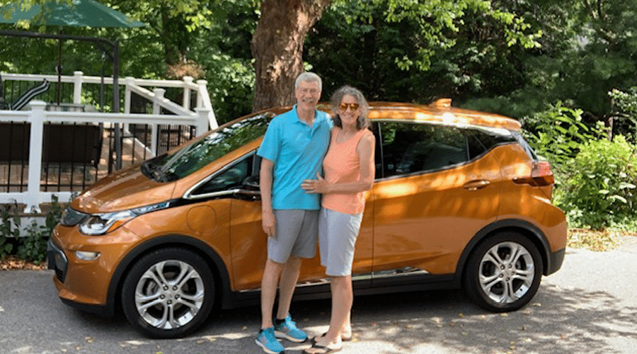 Chuck and Beth Huber with their EV car