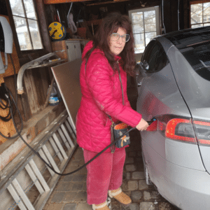 Ev owner charging tesla in garage