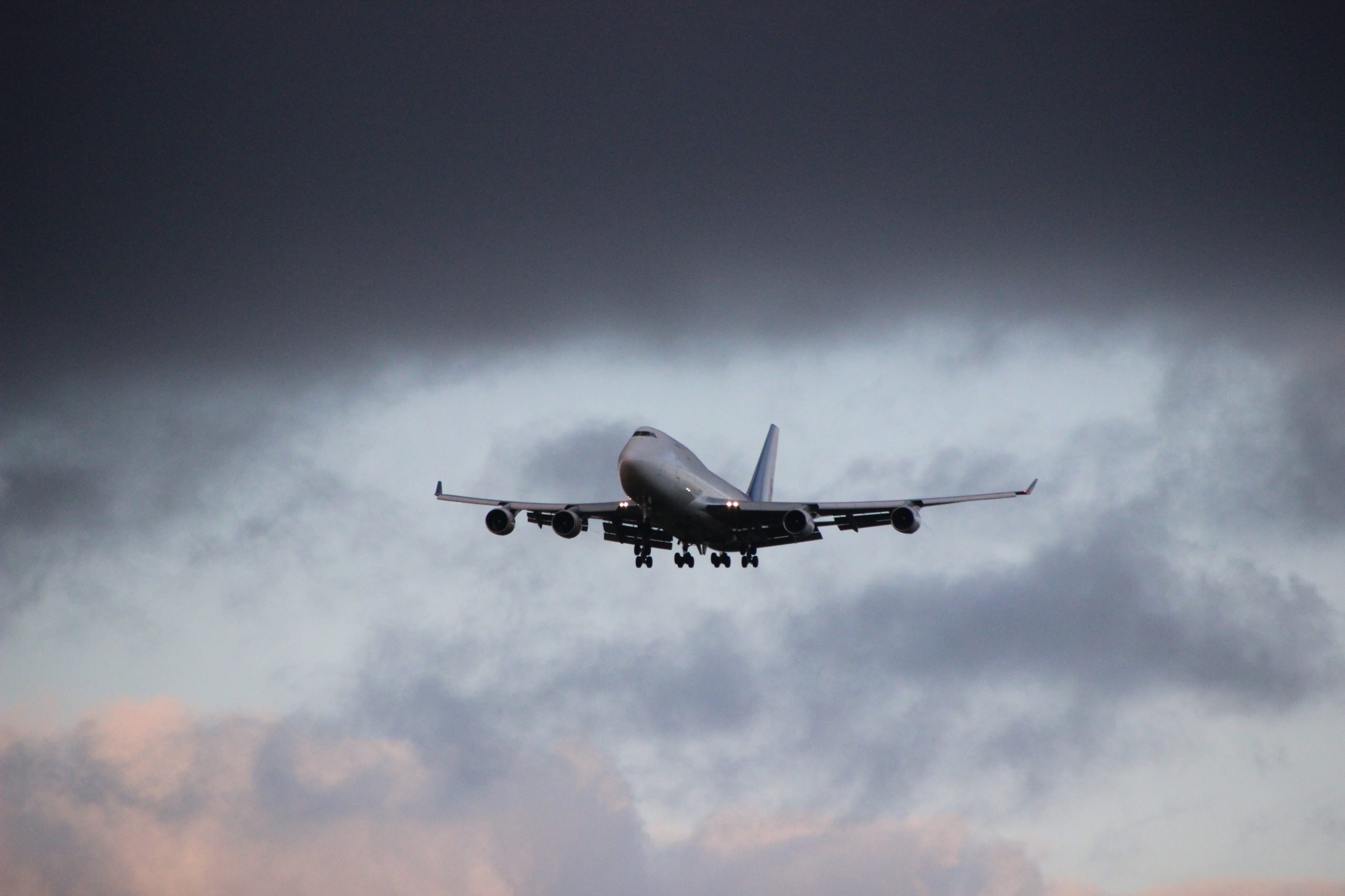 jumbo airplane jet flying in cloudy skies